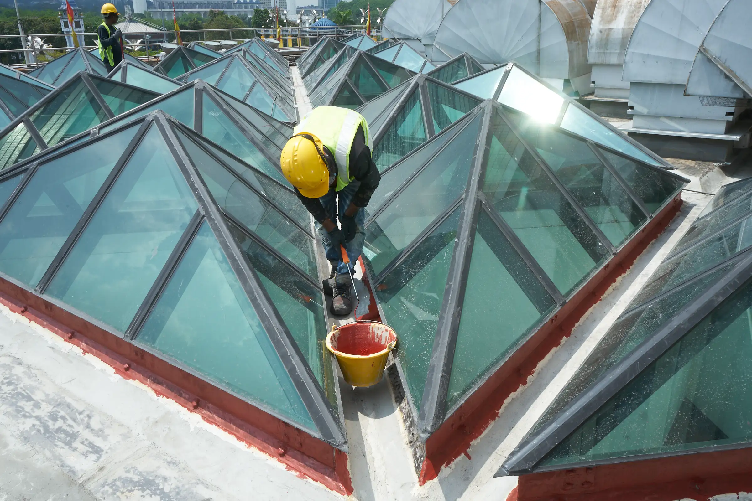 Waterproofing installation around geometric rooftop skylights in Malaysia